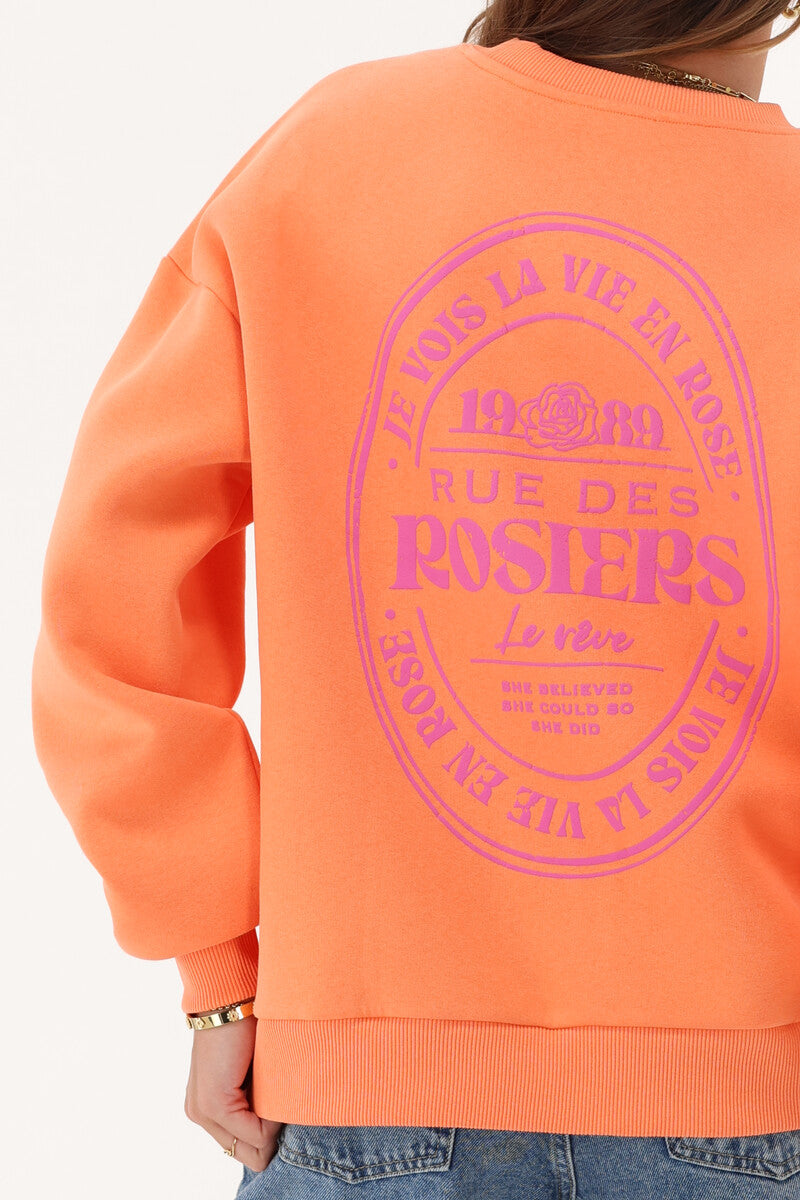 Oranges Sweatshirt mit pinken Aufdruck